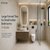 A modern, minimalist Indian bathroom featuring large format beige vitrified tiles on the walls and floor.