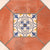 20040 Decor-2 Moroccan Vitrified Matt Tile 8x8 inch with terracotta red base, featuring colorful blue, white, and yellow traditional motifs, laid in a dining café setting.