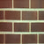 BT 903 Brick tile – a 3 inch by 9 inch brown clay-finish rectangular tile with a textured surface that emulates traditional brickwork, shown installed in a staggered brick-bond pattern, ideal for a warm accent wall in a kitchen, living room or feature area