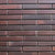 BT 915/902 Brick Tile in warm earthy brown tone, measuring 2 × 9 inches, with a natural clay texture that replicates traditional handmade brickwork. The image shows slim rectangular tiles arranged in a classic running bond pattern, ideal for rustic accent walls, kitchen backsplashes, or exterior cladding.