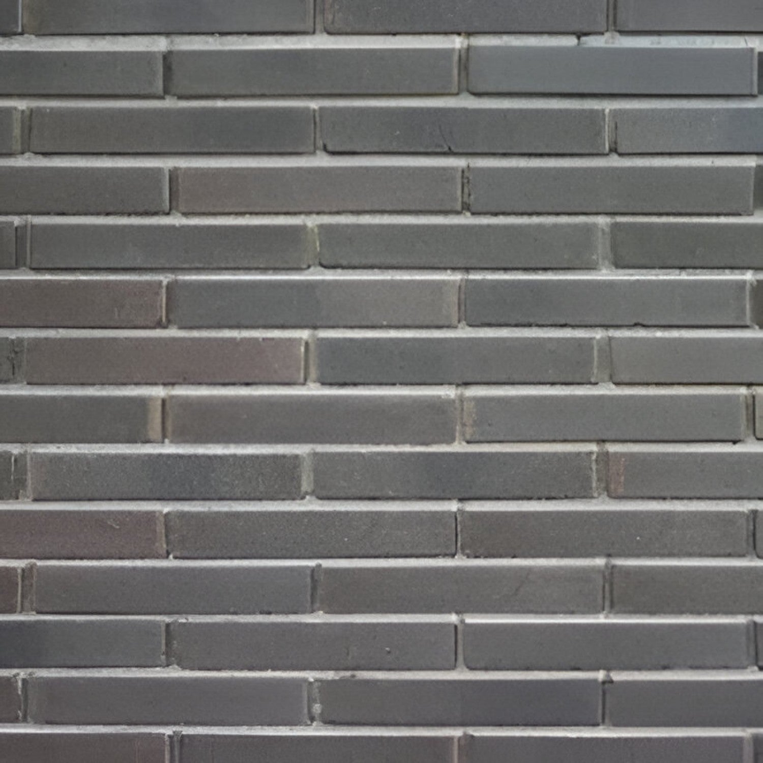 DB 601/615 Brick Tile in deep brown shade, measuring 3 × 9 inches, featuring a rugged clay texture with a natural brick appearance. The image shows rectangular tiles laid in a traditional brick bond pattern, ideal for rustic accent walls, exterior façades, or industrial-style interior designs.