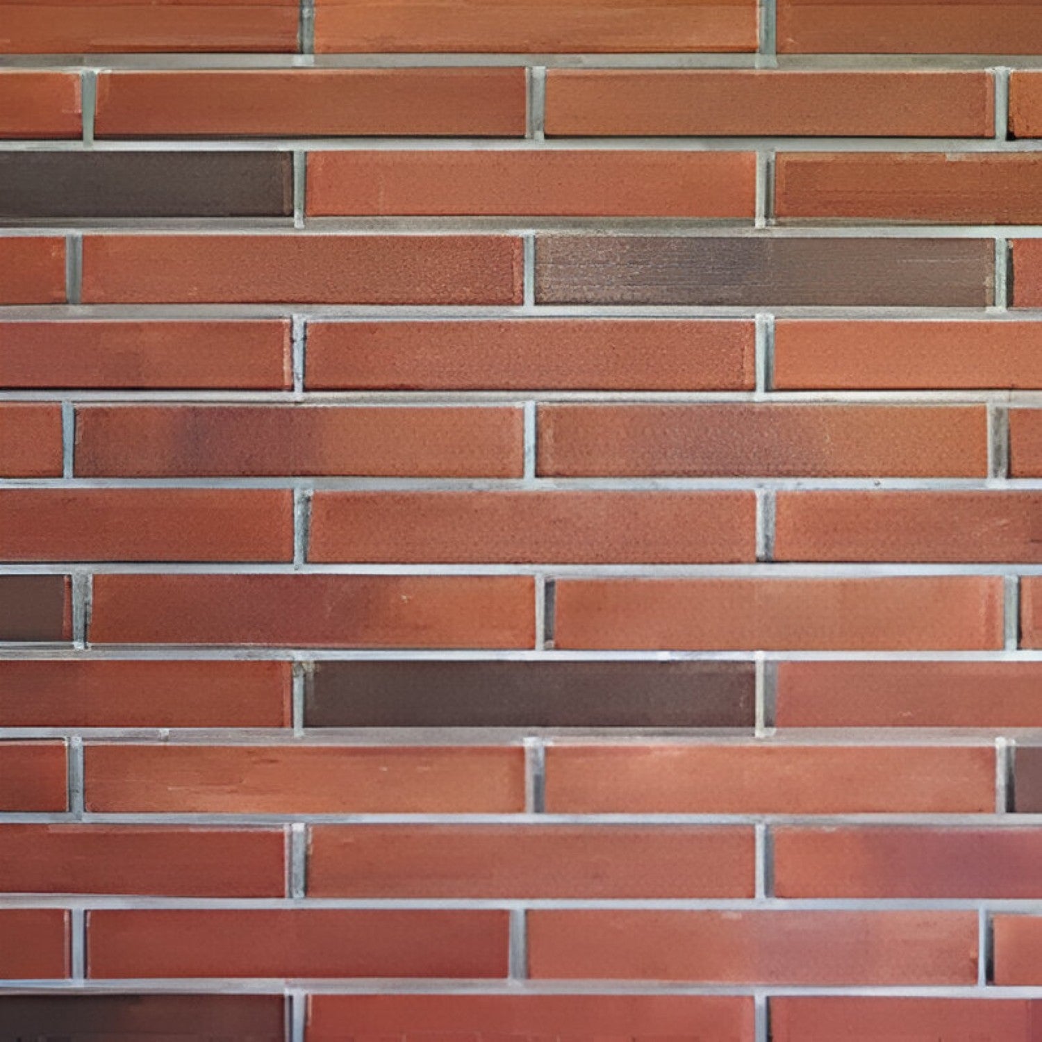 LB 915/902 Brick Tile in earthy brown shade, 2 × 9 inches, featuring a textured clay surface that mimics authentic brickwork. The image shows narrow rectangular tiles arranged in a running bond pattern, ideal for accent walls, kitchen backsplashes, or rustic and contemporary interior décor
