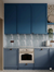 Lucido Base Celeste vitrified gloss tile in 8 x 8 inch size installed on a modern kitchen wall and floor, featuring a smooth plain surface with a reflective glossy finish, creating a clean and sophisticated interior setting with durable vitrified construction suitable for residential and commercial kitchen spaces.