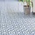 M‑10124 Ceramic Moroccan Tile – 12×12 inch matte ceramic tile in serene blue, featuring a continuous white floral and rangoli-style pattern for an elegant Moroccan-inspired design.