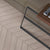 Oaklore Cemento Chevron Wooden Tile 6x36 Inch, featuring soft grey oak tones arranged in a chevron pattern, perfect for modern and durable flooring or wall applications.
