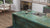 Premium Amazonite quartz kitchen countertop slab with glossy polished surface installed in a modern interior setting, featuring a seamless large-format design suitable for kitchen counters, dining table tops, workspaces, and contemporary residential or commercial applications.