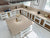 Premium Desert Sand quartz kitchen countertop slab with polished glossy finish installed in a modern luxury kitchen interior featuring a seamless engineered quartz surface ideal for kitchen counters, islands, dining tables, vanity tops, and contemporary residential or commercial spaces with elegant detailing and spacious slab design.