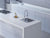 Premium Super White quartz kitchen countertop slab with polished gloss finish installed in a modern modular kitchen interior, featuring a smooth engineered stone surface ideal for kitchen counters, islands, dining table tops, and contemporary workspace applications with seamless luxurious appeal.