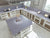 Pure Cemento quartz kitchen counter top slab with smooth gloss finish installed in a modern kitchen interior featuring seamless countertop design, premium quartz surface texture, spacious layout, elegant contemporary styling, and large-format engineered stone slab suitable for kitchen islands and table tops.