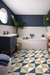 Radiant Moroccan Vitrified Tile – 16×16 inch matt-finish vitrified tile in a vibrant palette of blue and yellow, featuring a printed Moroccan-rangoli geometric and floral pattern designed for both floor and wall applications.