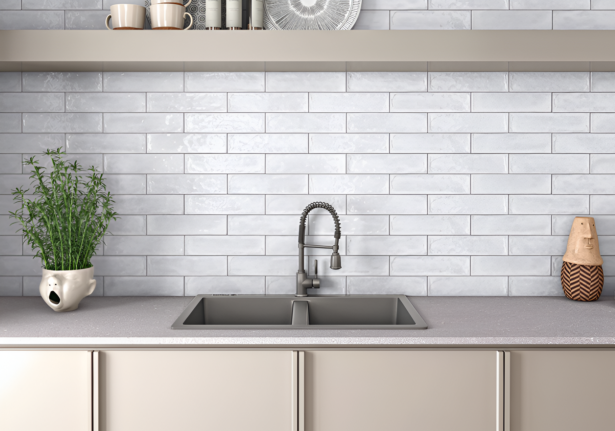 Modern kitchen with a sink, faucet, and decorative items against a white subway tile