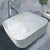 TTH-023-1 terrazzo ceramic countertop washbasin placed on a modern vanity, showcasing its square shape, smooth ceramic surface, and designer terrazzo pattern with a deep, functional bowl structure.