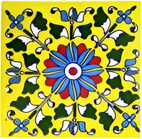 TTH-361 Ceramic Tile 3 x 6 Inch – Handmade ceramic tile featuring a vibrant floral medallion design on a yellow background with blue, red, green, and white detailing, displayed on a wooden surface.