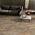 Volcano Brown Wooden Plank 8x48 Inch vitrified floor tile showcasing rich natural brown wood grains and matt textured wooden plank design installed in a modern living room interior floor setting
