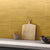 Wave Ochre subway tile in 3 × 9 inch size featuring a warm ochre tone with a subtle wave-textured surface and matt finish, installed on an interior wall to create a stylish and modern backsplash with a soft, natural look.