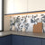 Cubique Bianco geometric 24x24 inch tile on a kitchen backsplash with navy cabinets